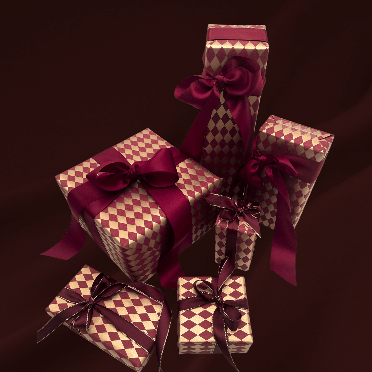 Diamonds Burgundy Christmas wrapping paper with wrapped gifts and burgundy ribbon