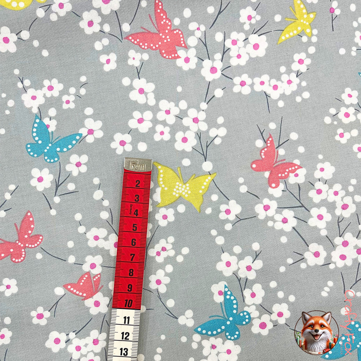 Measuring tape in red showing size of Butterflies