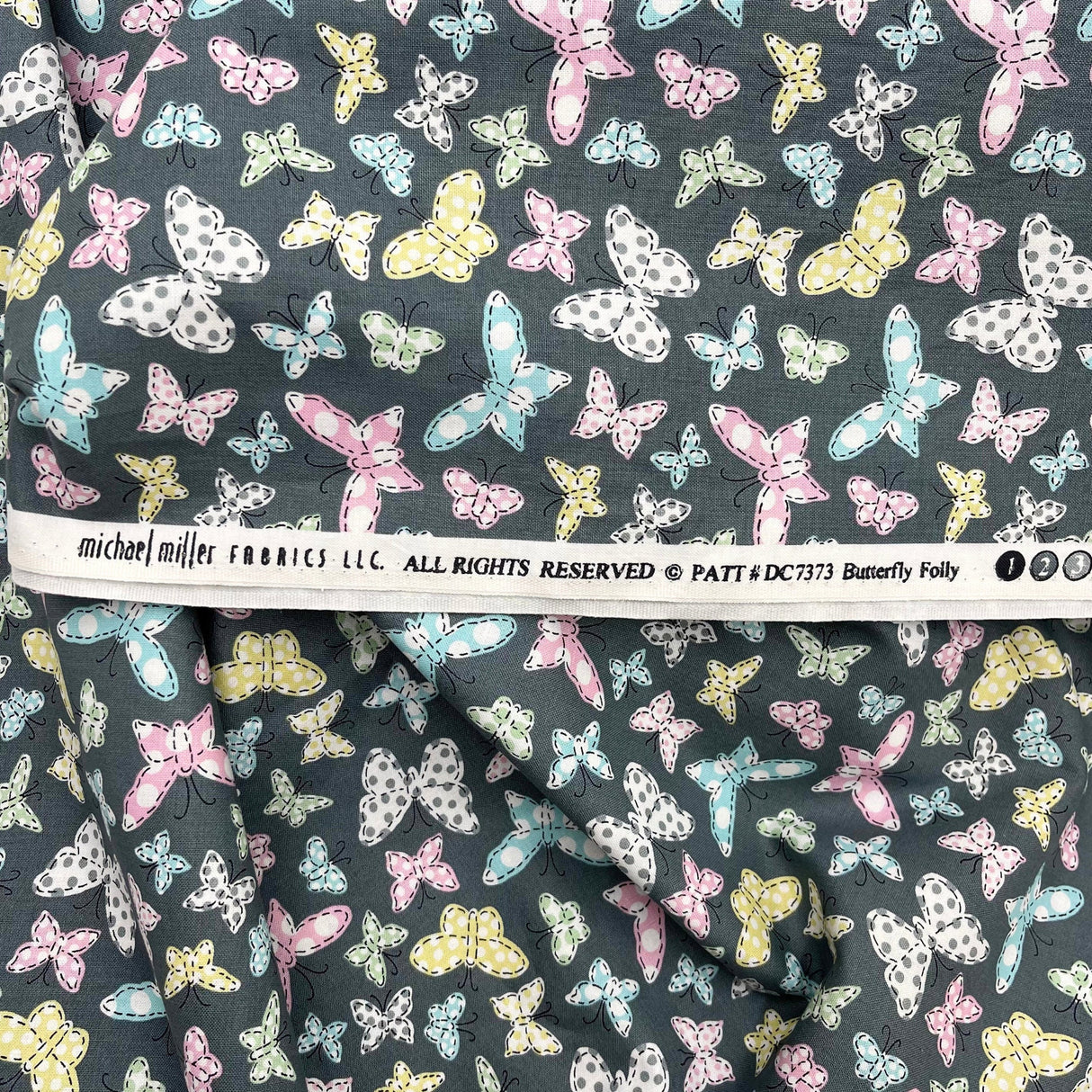 Butterfly Folly Fabric: Multi-Coloured Butterflies on Charcoal - Michael Miller