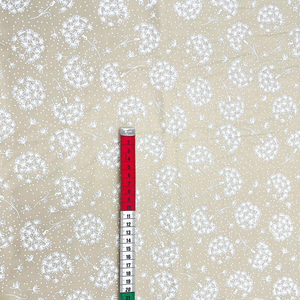 red and white measuring tape showing size
