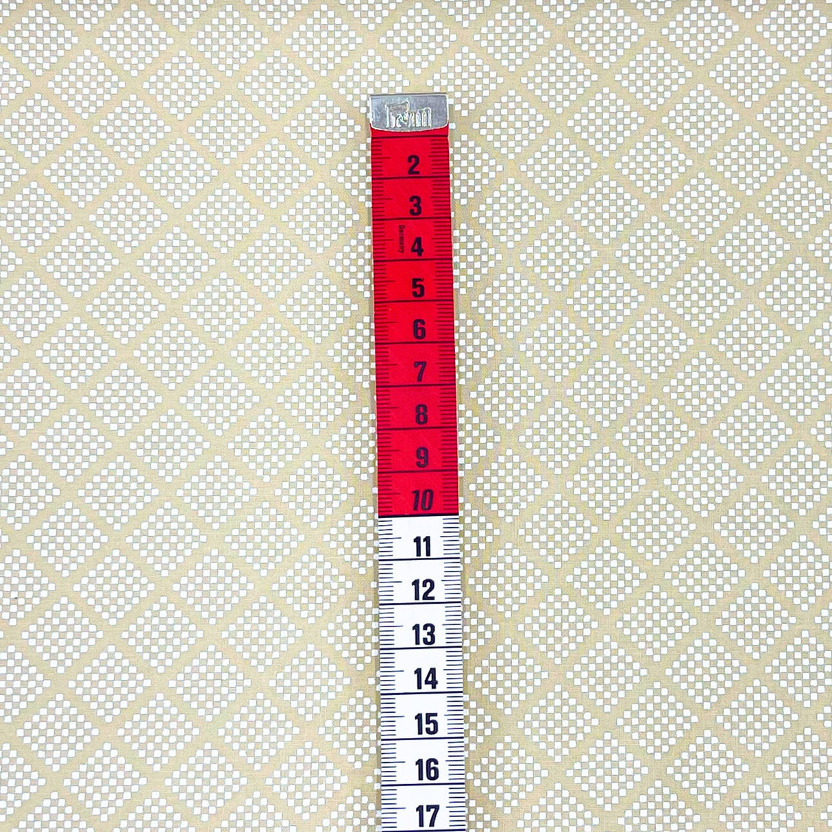red and white tape measure showing centimetres size of pattern