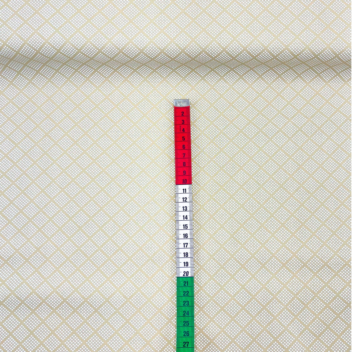 red, white and green measuring tape on fabric