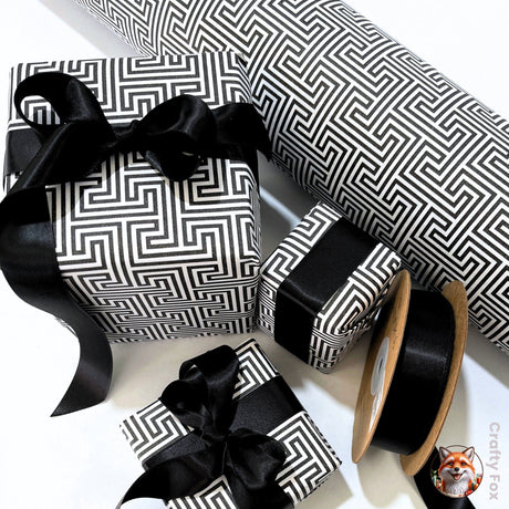 Black satin ribbon paired with black and white geometric gift wrapping paper