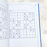 Inside pages of Sudoku puzzle book showing easy Sudoku grids for beginners