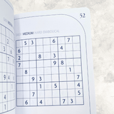 Medium difficulty Sudoku puzzle grids inside the faux suede Sudoku puzzle book