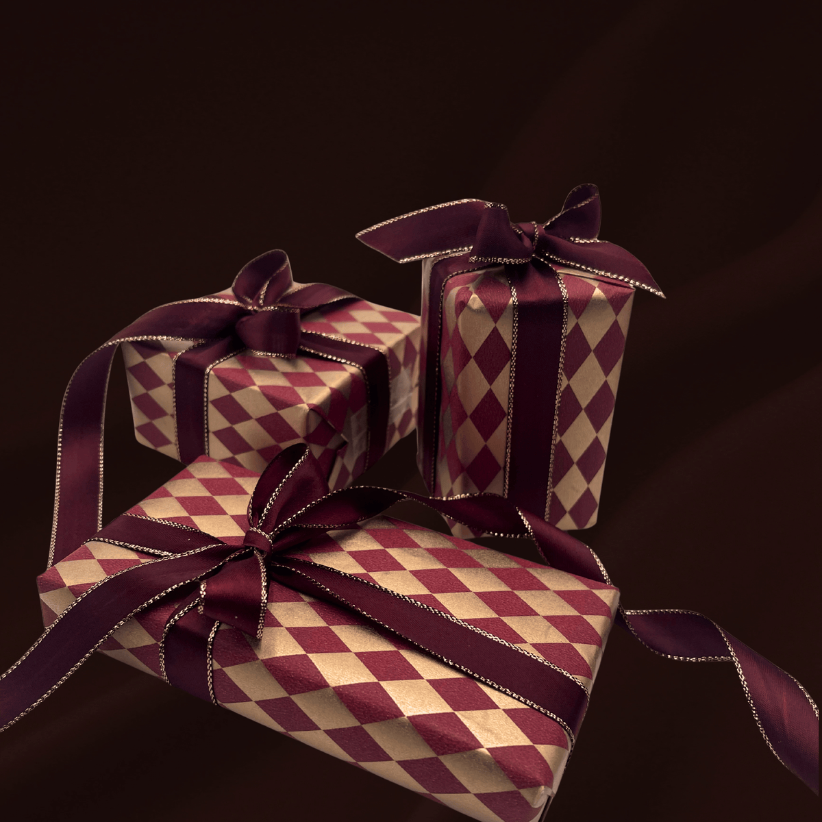 Gold and burgundy diamond Christmas gift wrapping paper with burgundy satin ribbon
