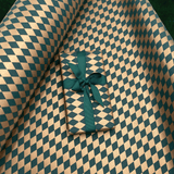 Gold and forest green diamond Christmas gift wrapping paper with evergreen grosgrain ribbon