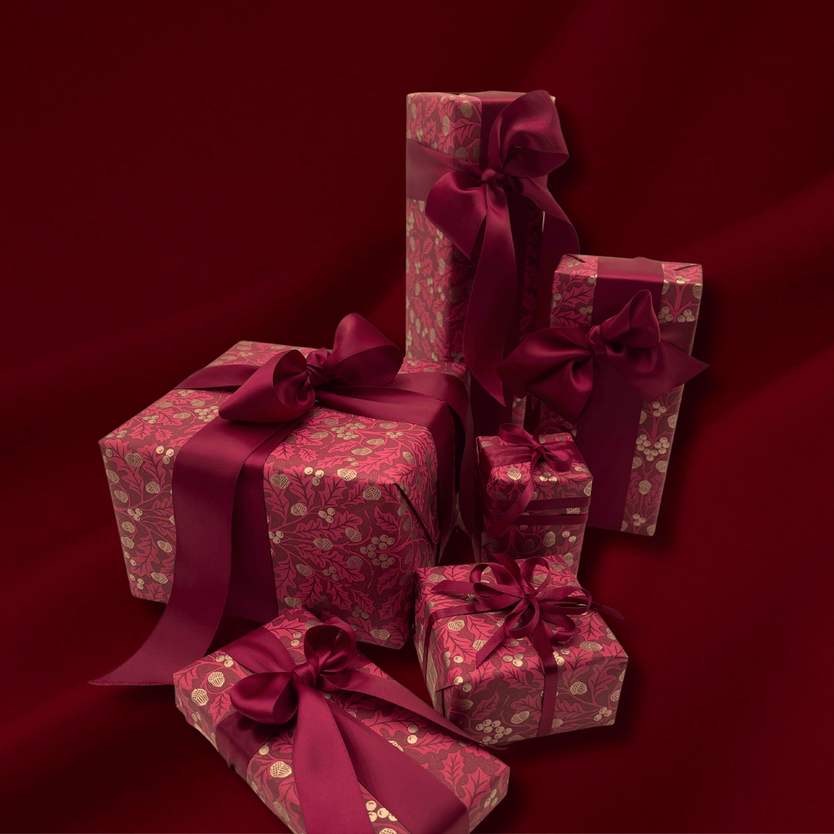 Harvest Burgundy Christmas wrapping paper with burgundy satin ribbon and wrapped gifts