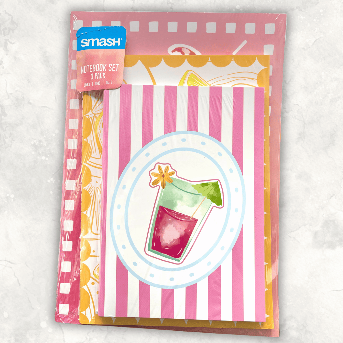 Smash notebook set of 3 in original shrink-wrap packaging, featuring colourful pink, orange and yellow designs with lined, grid and dotted pages.