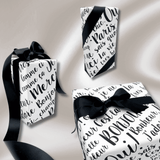 Collection of beautifully wrapped gifts featuring Paris black and white pearlised wrapping paper with luxurious black satin ribbon.