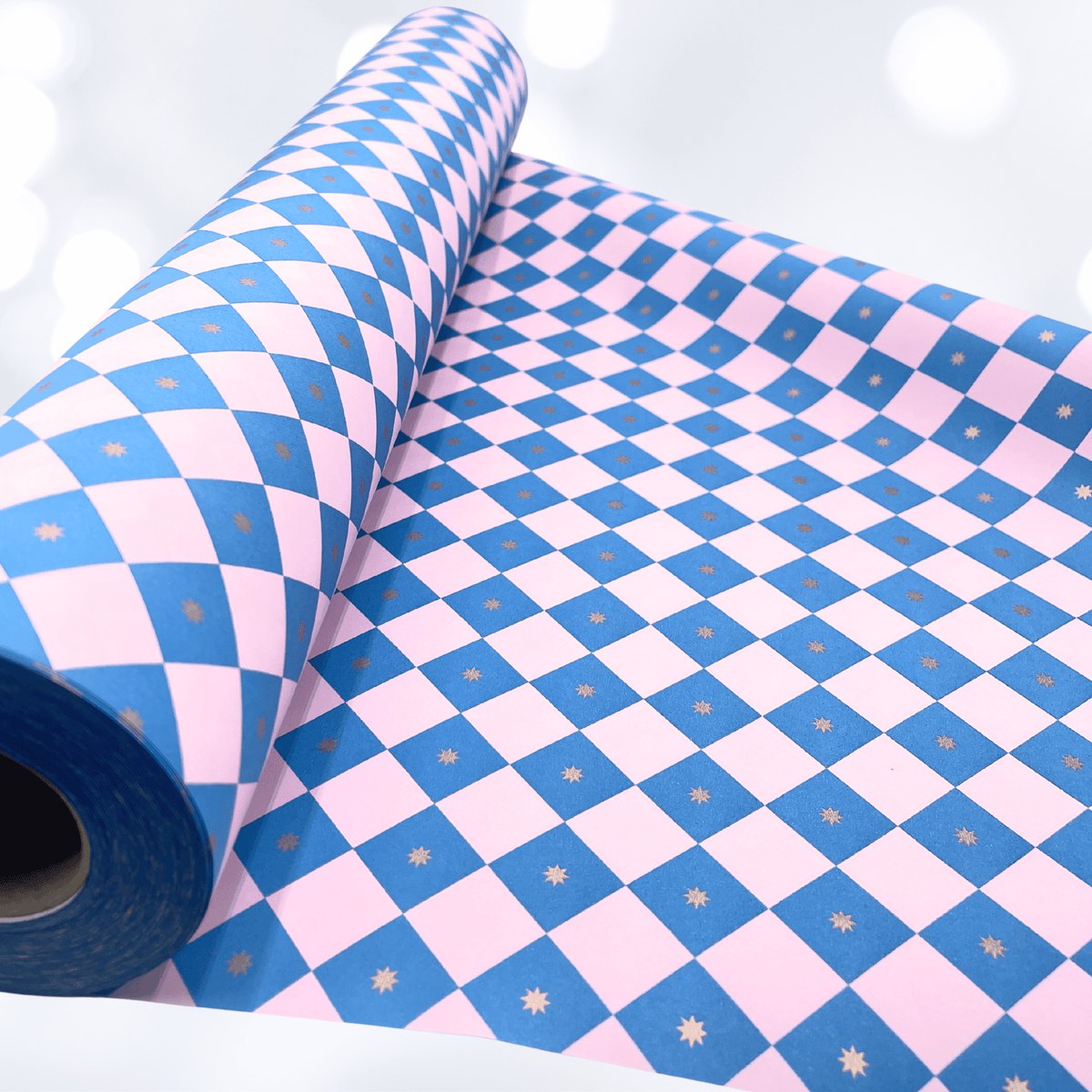 Close-up of electric blue and pink diamond checkerboard gift wrapping paper showing the bold geometric pattern and matte finish