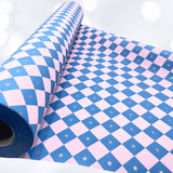 Close-up of electric blue and pink diamond checkerboard gift wrapping paper showing the bold geometric pattern and matte finish