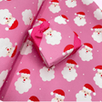 Santa Pink Christmas gift wrapping paper with cheerful Santa face design
