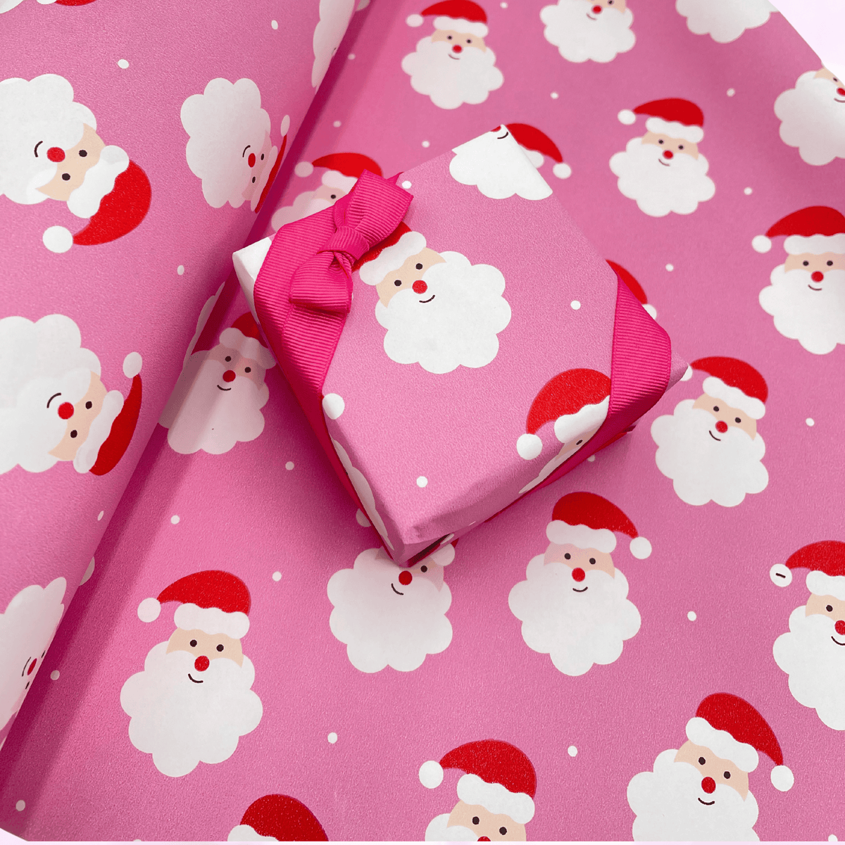 Santa Pink Christmas gift wrapping paper with cheerful Santa face design