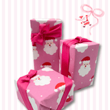 Bright pink Santa Christmas wrapping paper styled with pink ribbon