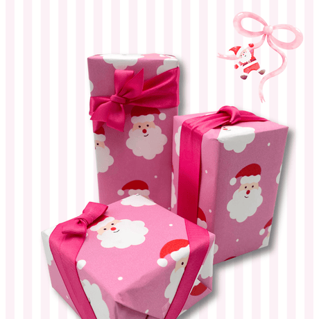 Bright pink Santa Christmas wrapping paper styled with pink ribbon