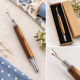 Hand-turned wooden seam ripper with honey and brown timber grain, polished chrome details and sewing accessories.