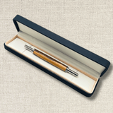 Handmade two-tone wooden seam ripper presented in an open black gift box with light-coloured lining.