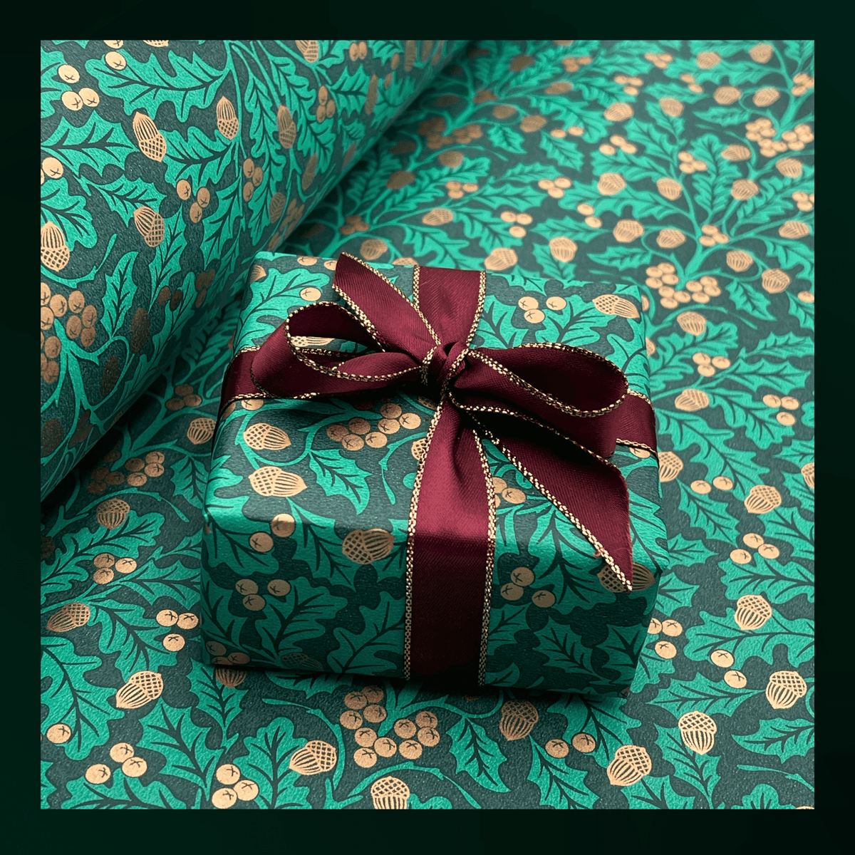 Xmas Harvest Green Christmas gift wrapping paper with golden acorns, foliage and burgundy satin ribbon