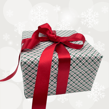 Pearl red satin ribbon with gold shimmer tied around Christmas gift wrapping paper