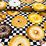 Side view of fabric of Bagels showing a  variety of bagels, category for Food Drink, this is Quilting, Cotton, Novelty Fabric, by Timeless Treasures Fabrics - Fabric Code TT-GM.C6003