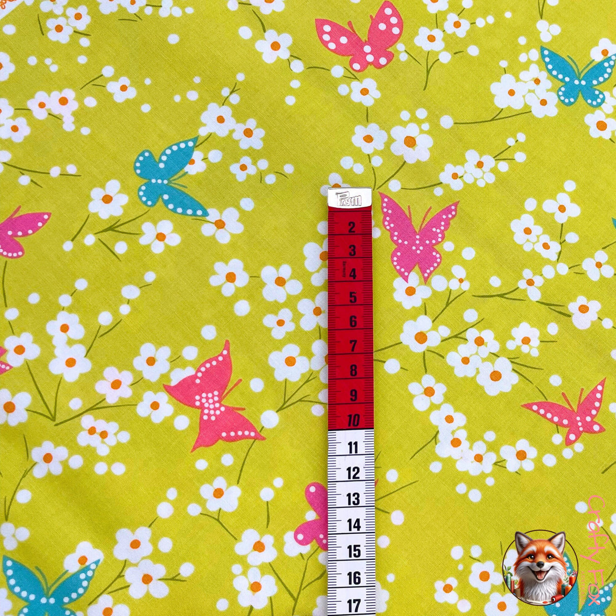 Measuring tape showing size of Pink Butterfly of Butterfly Blossom on a lime green background
