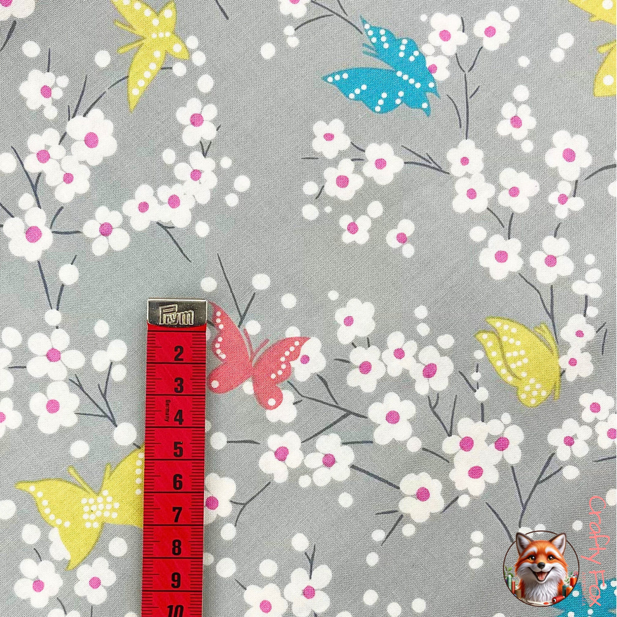 Vertical view of measuring tape showing measurements of Pink Butterfly on fabric