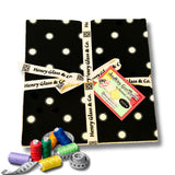 Threads and tape measure in foreground with Layer cake fabric pack